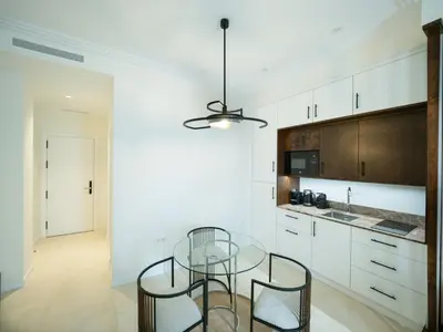 a kitchen with a glass table and some white cabinets at AT La Maquinilla in Jerez de la Frontera
