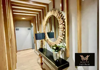 a hallway with a mirror and a vase on a table at Mape Loft Rural Aljibe in Algar