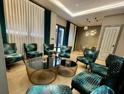 a living room with blue chairs and a table and chairs at Mape Loft Rural Aljibe in Algar