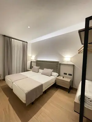 a hotel room with two beds and a window at Mape Loft Rural Aljibe in Algar