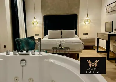 a bathroom with a bath tub and a bed at Mape Loft Rural Aljibe in Algar