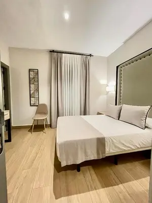 a bedroom with a large bed and a desk at Mape Loft Rural Aljibe in Algar