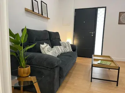a living room with a couch and a table at La Gañanía in Jerez de la Frontera