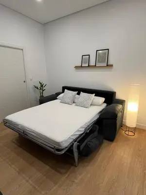 a large bed in a room with a couch at La Gañanía in Jerez de la Frontera