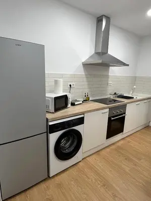 a kitchen with a microwave and a stove top oven at La Gañanía in Jerez de la Frontera