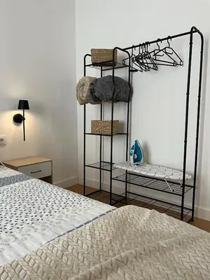 a room with a bed and a shelf with baskets at La Gañanía in Jerez de la Frontera