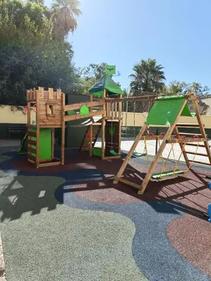 a playground with a slide and a swing set at piso LuMa in Jerez de la Frontera