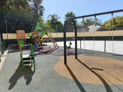 a playground with a swing set and a slide at piso LuMa in Jerez de la Frontera