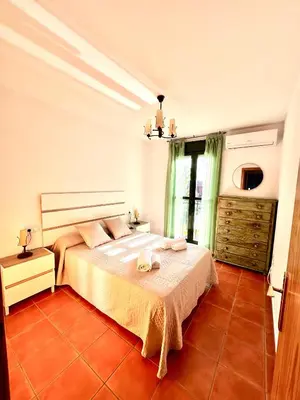 a bedroom with a large bed and a window at Apartamento La Barrosa - Aldea del Coto in Novo Sancti Petri