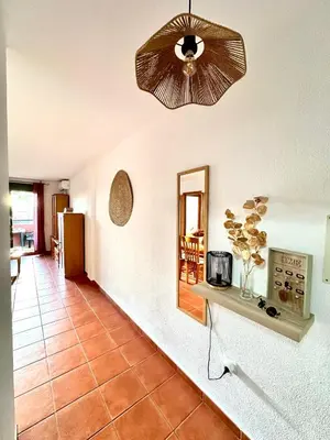 a living room with a ceiling fan and a tile floor at Apartamento La Barrosa - Aldea del Coto in Novo Sancti Petri