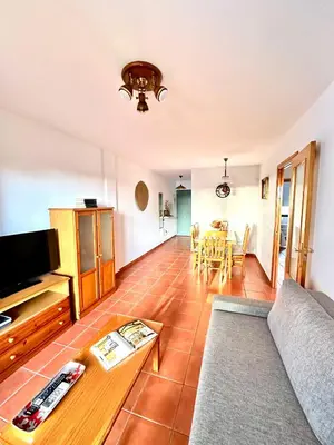 a living room with a couch and a table at Apartamento La Barrosa - Aldea del Coto in Novo Sancti Petri