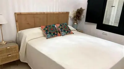 a bed with two pillows on it in a bedroom at Martiniano in Conil de la Frontera
