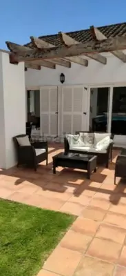 a patio with a couch and a coffee table at Martiniano in Conil de la Frontera