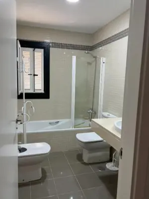 a bathroom with a toilet and a tub and a sink at Martiniano in Conil de la Frontera