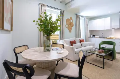 a living room with a table and chairs at Genteel Home Patrocinio Cádiz in Cádiz