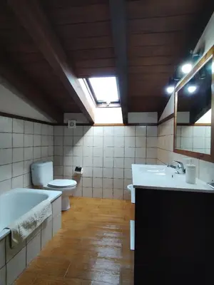 a bathroom with a tub and a toilet and a sink at Casa Sebas in Conil de la Frontera