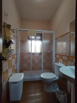 a bathroom with a shower and a toilet and a sink at Casa Sebas in Conil de la Frontera