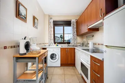 a kitchen with a washer and dryer at Barrosa Beach Apartment - Chiclana de la Frontera in Novo Sancti Petri