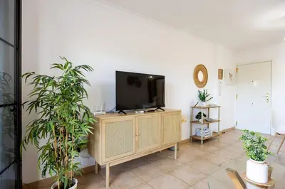 a living room with a tv and some plants at Barrosa Beach Apartment - Chiclana de la Frontera in Novo Sancti Petri