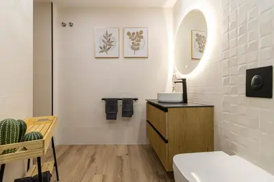 a bathroom with a sink and a mirror at Casa Palacio Marqués de Castellanos in Jerez de la Frontera