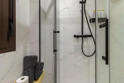 a bathroom with a shower with a glass door at Casa Palacio Marqués de Castellanos in Jerez de la Frontera