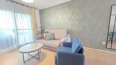 a living room with a couch and a table at La San Sebastián del Sur by Sanlúcar Housing in Sanlúcar de Barrameda
