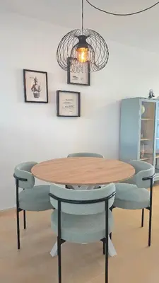 a dining room with a wooden table and chairs at La San Sebastián del Sur by Sanlúcar Housing in Sanlúcar de Barrameda