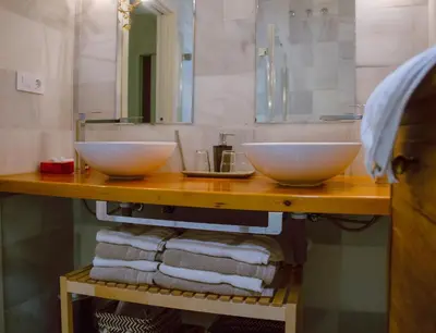 a bathroom with two sinks and towels on a counter at Apartamento Bizcocheros con piscina y jardín privado in Jerez de la Frontera