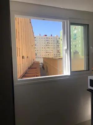 a window in a room with a view of a building at Playa, Sol y Relax in Cádiz