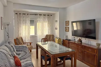 a living room with a couch and a tv at Playa, Sol y Relax in Cádiz