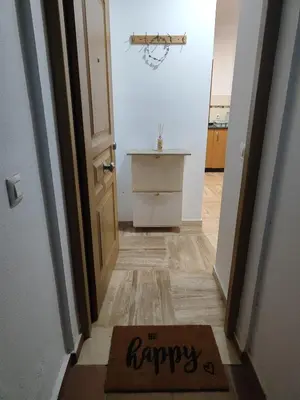 a happy mat on the floor in front of a door at Apartamento planta baja con jardín privado in Novo Sancti Petri