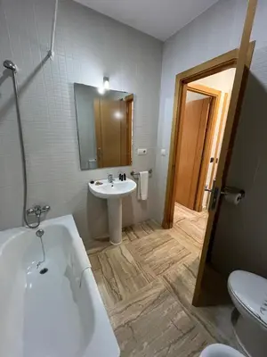 a bathroom with a tub and a sink and a toilet at Apartamento planta baja con jardín privado in Novo Sancti Petri