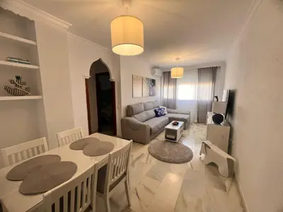 a living room with a table and a couch at Puertas del Mar 1 in Puerto Real