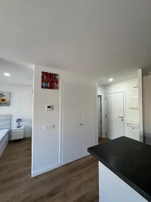 a kitchen with white cabinets and a counter top at Roomy Estudio in Jerez de la Frontera