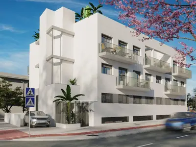 a white building with cars parked in front of it at Roomy Estudio in Jerez de la Frontera