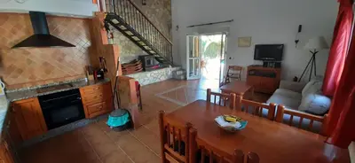 a villa with a swimming pool in front of a house at Casa Palmera in Conil de la Frontera