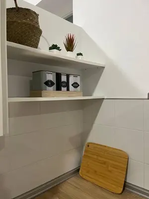 a wooden stool sitting on a shelf in a room at Porvernir 10 in Jerez de la Frontera