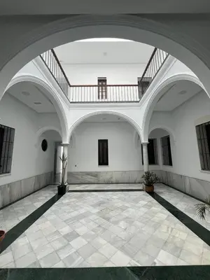 an empty room with a staircase in a building at Porvernir 10 in Jerez de la Frontera