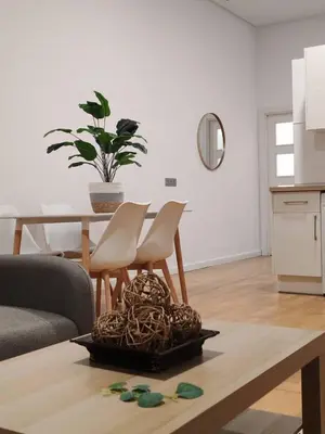a living room with a table and chairs at Porvernir 10 in Jerez de la Frontera