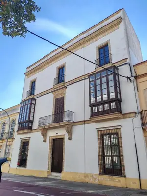an old white building with windows and balconies at Porvernir 10 in Jerez de la Frontera