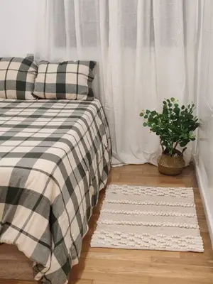 a bedroom with a bed and a potted plant at Porvernir 10 in Jerez de la Frontera