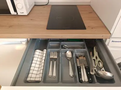 a drawer filled with utensils in a refrigerator at Apartamento Fino in Jerez de la Frontera