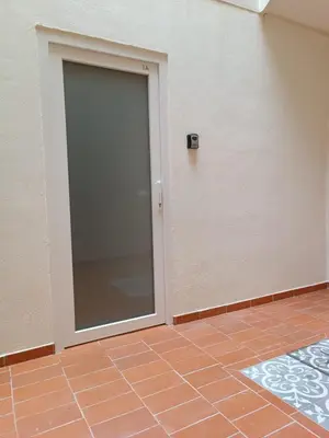 a sliding glass door in a room with a tile floor at Apartamento Fino in Jerez de la Frontera