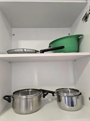 two pots and pans on a shelf in a kitchen at Apartamento El Taranto in Jerez de la Frontera