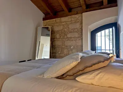 a bedroom with a large bed with a window at Sherry de la Riva - Ole Solutions in Jerez de la Frontera