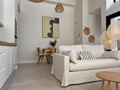 a living room with a white couch and a table at Sherry de la Riva - Ole Solutions in Jerez de la Frontera