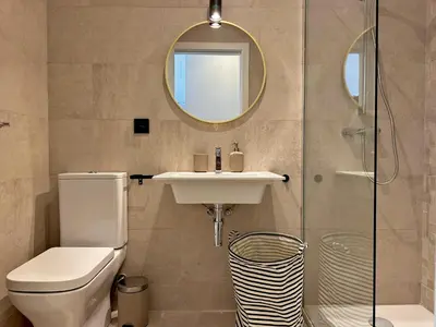 a bathroom with a toilet and a sink and a mirror at Sherry de la Riva - Ole Solutions in Jerez de la Frontera