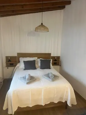 a bedroom with a large bed with towels on it at Apartamentos Sun 65 in Jerez de la Frontera