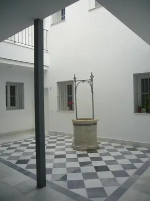 a room with a fountain in the middle of a building at Tacita Investments,SL in Cádiz