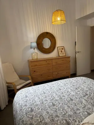 a bedroom with a bed and a dresser with a mirror at Tacita Investments,SL in Cádiz